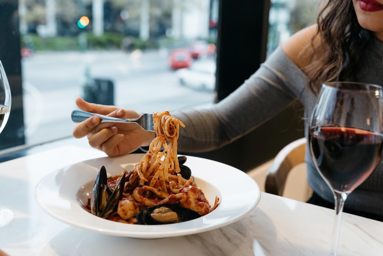 Art Series - The Chen Box Hill Extérieur photo A woman eating a pasta dish